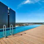 Stunning rooftop infinity pool with city skyline view in New York. Perfect summer oasis.